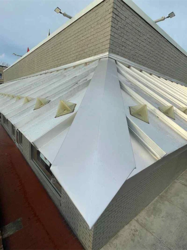 Standing seam metal roof installation in progress